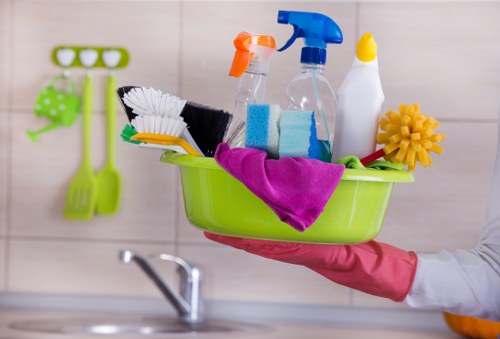 Local cleaner working on upper-floor windows in Elephant and Castle