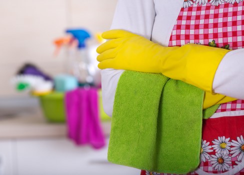 Cleaning kitchen cupboards and surfaces before moving into a property